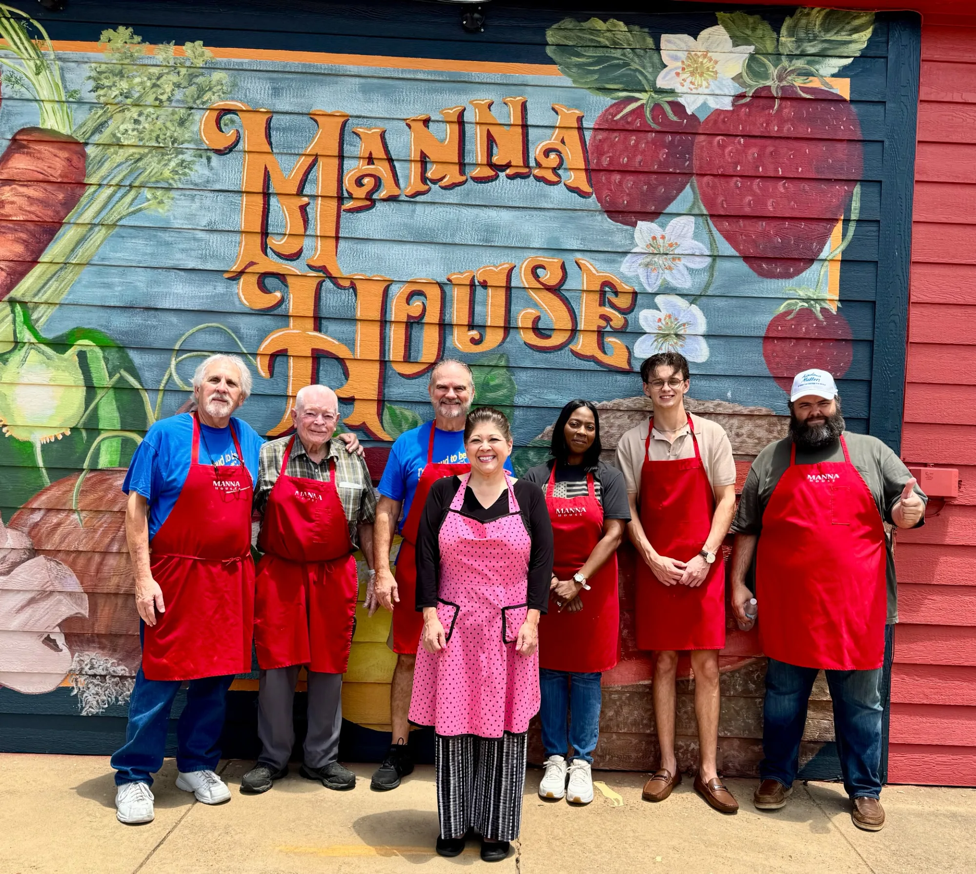 Volunteers at the Manna House mural